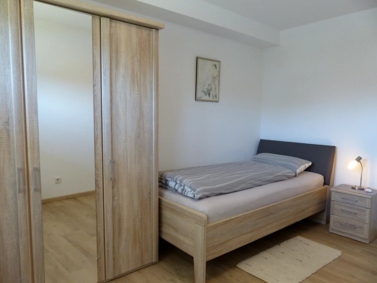 Kleines Schlafzimmer mit Einzelbett und Schrank